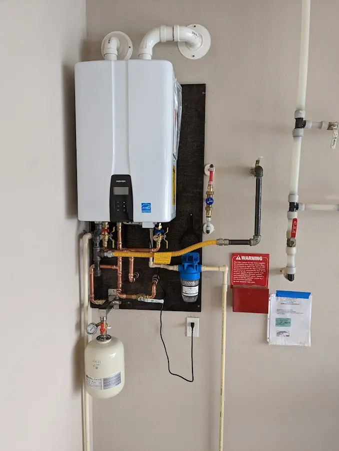 Professional plumber installing copper piping in a Grants Pass home